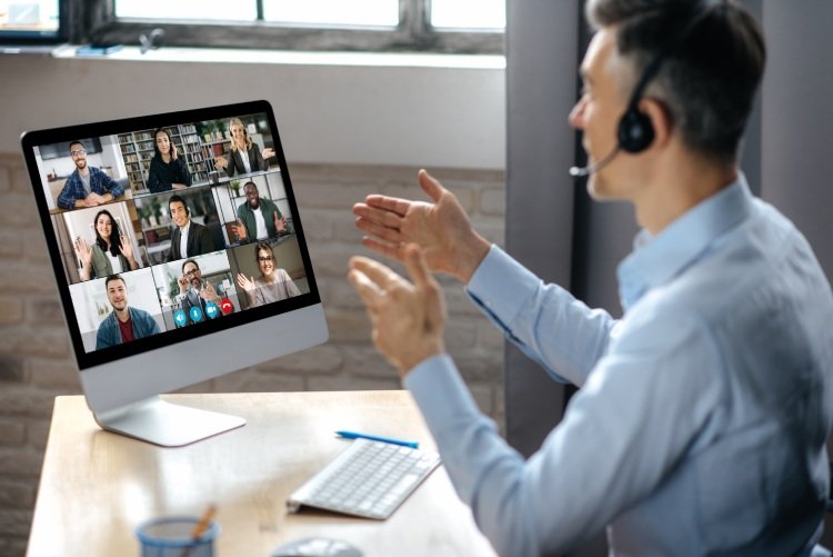 Man speaking to attendees on virtual conference platform